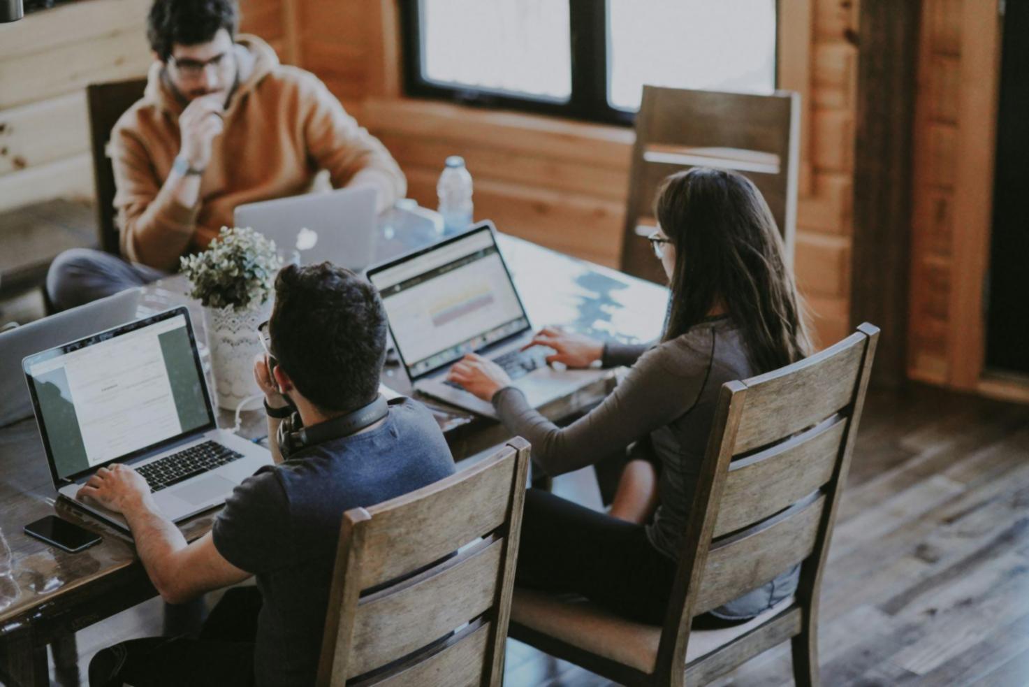 Modern office workspace in New Taipei City showing trading monitors and economic research materials